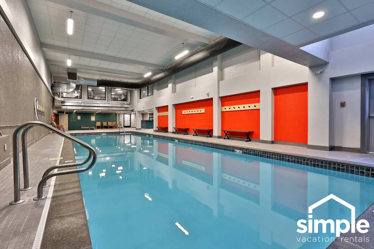 This image captures the bright, inviting indoor swimming pool at Mountain Green, with poolside seating and colorful walls. The scene conveys relaxation and rejuvenation—exactly what's promised in the 'Resort-Style Perks' paragraph after a day on the mountain.